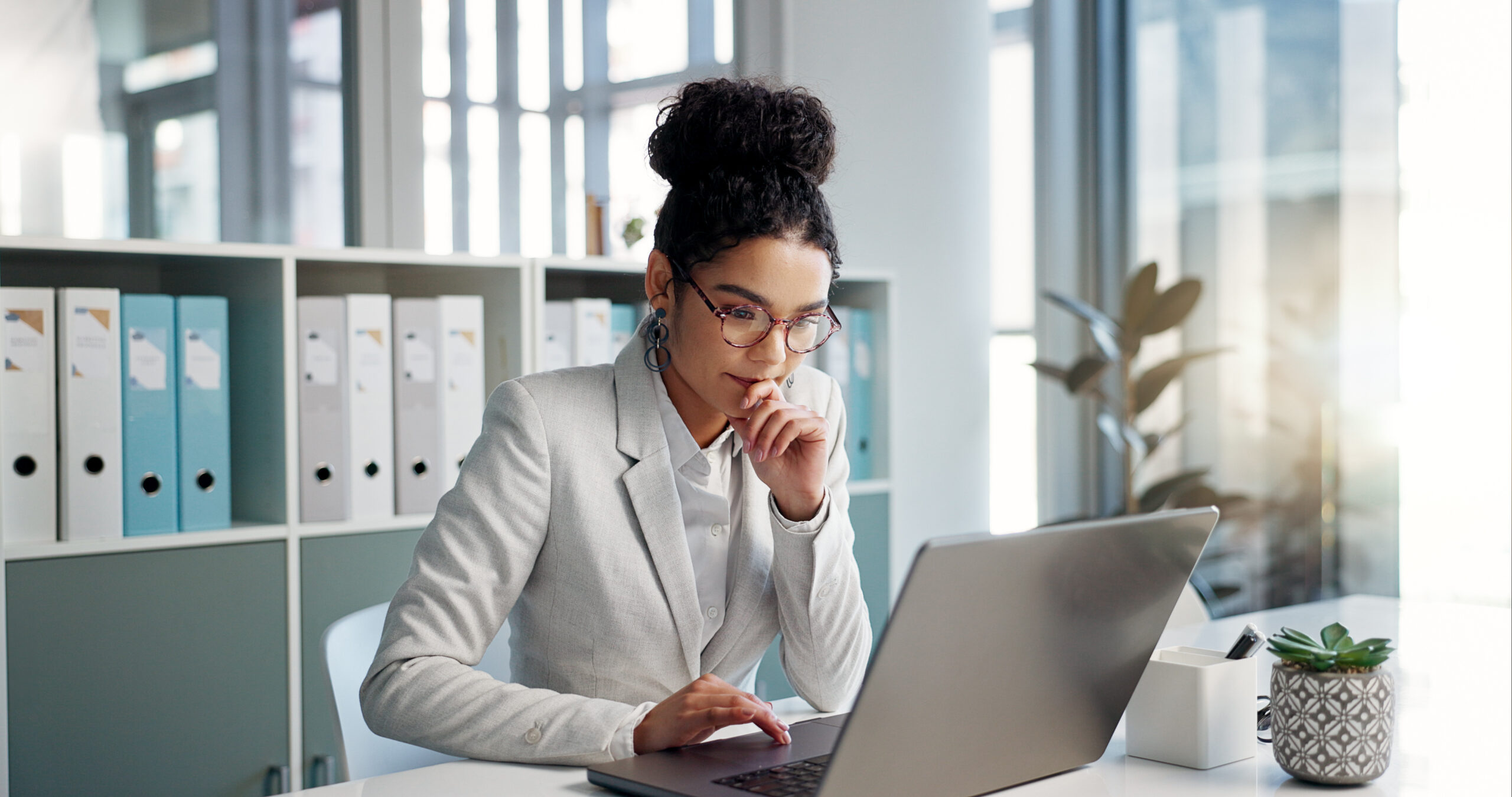 Thinking, laptop and typing business woman, bank consultant or working on research report, project or solution. Computer, administration analysis and professional person reading online account data